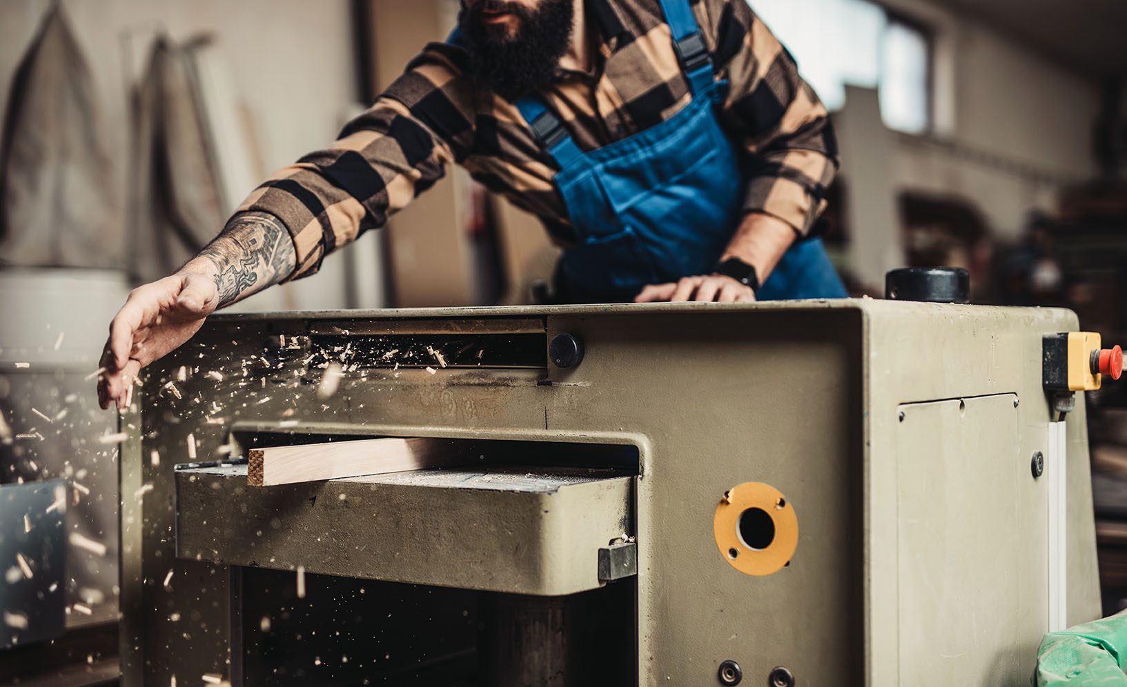 Focused professional carpenter working in his workshop, woodwork